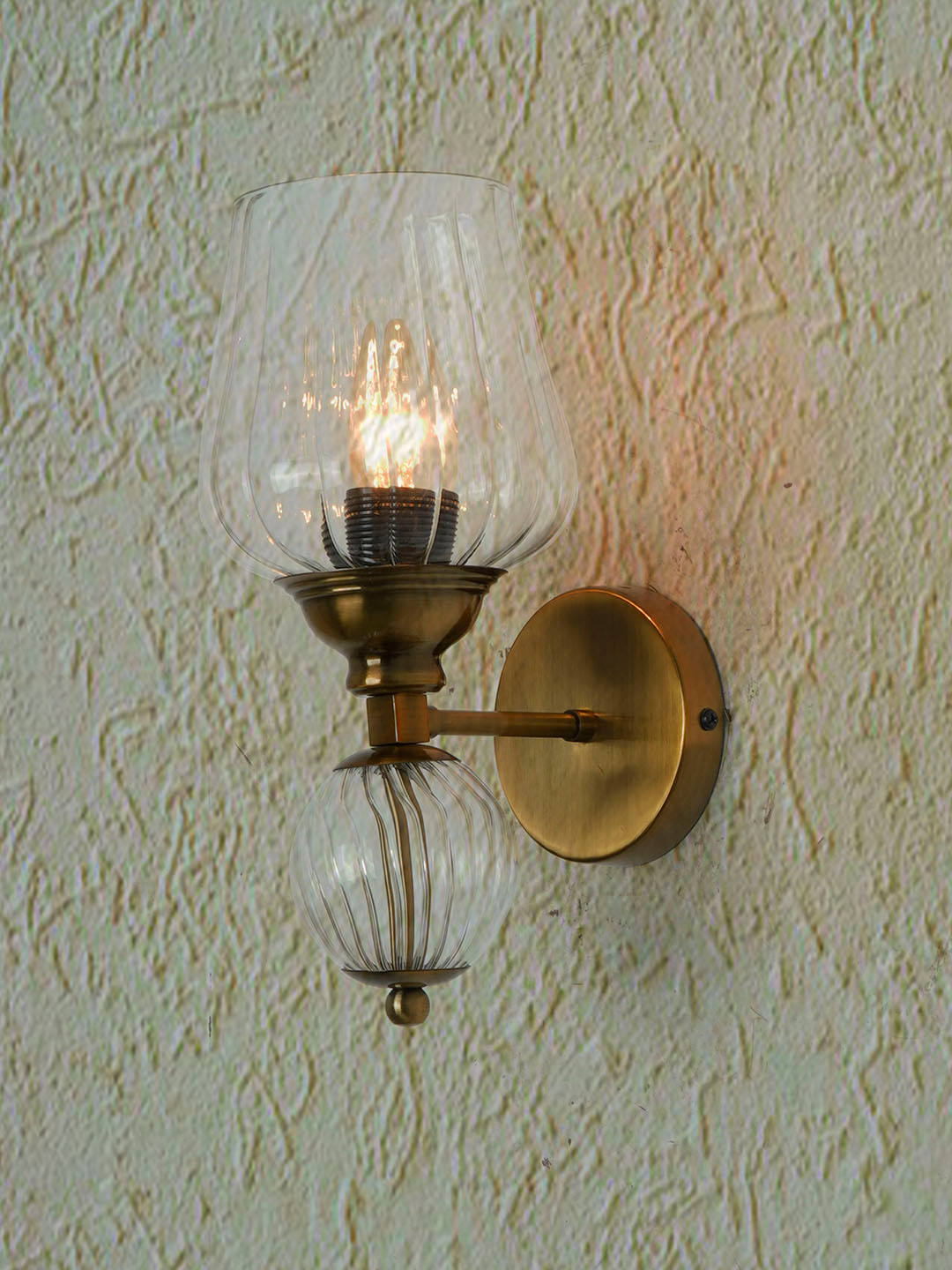 Antique Brass Finish Mild Steel Wall Sconce Accented with a Glass Ball and Fluted Glass Goblet Diffuser