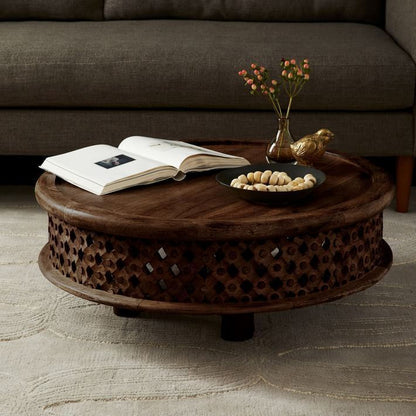 This coffee table is a center table made of solid mango wood and hand carved. And it has round top with brim surface.