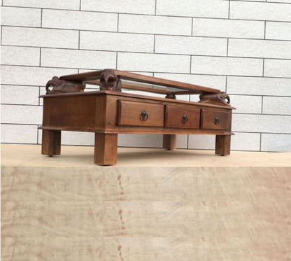 Asgil coffee table with assorted hand carving elephants with 3 drawers. side view