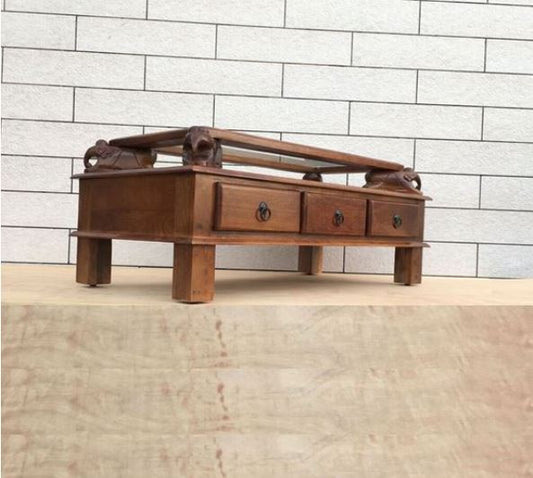 Asgil coffee table with assorted hand carving elephants with 3 drawers. side view