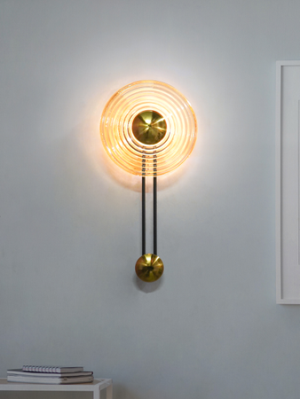 Modern Golden Pendulum-Style Steel And Round Amber Glass Decorative LED Wall Lamp placement in home